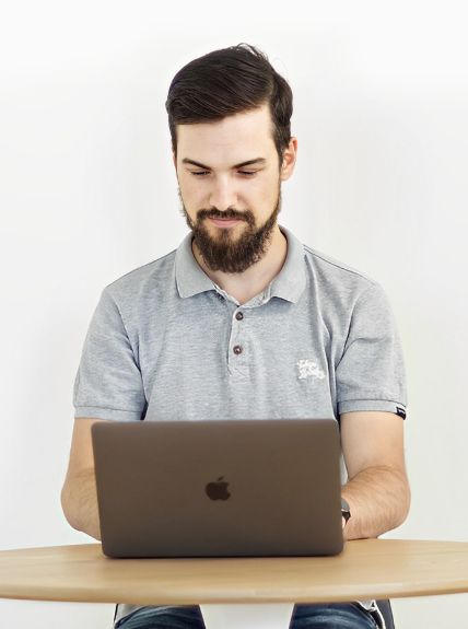 Alex working at a laptop